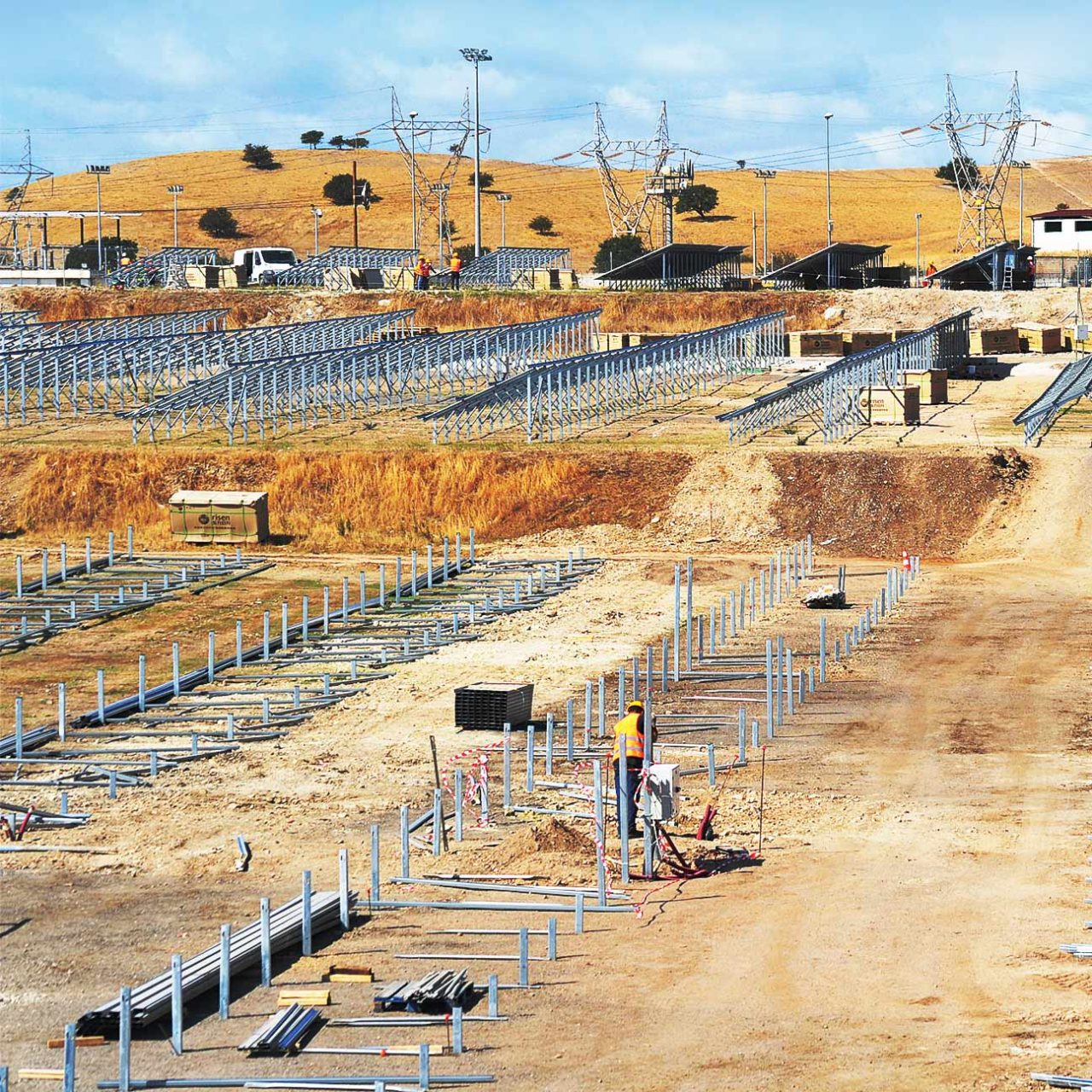 Person installing solar panels on PV plant