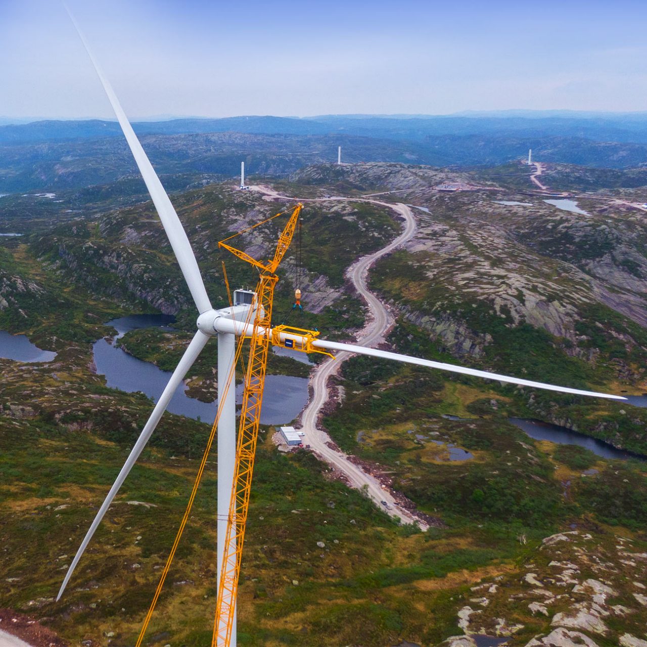 Crane and turbine blades with hills in background