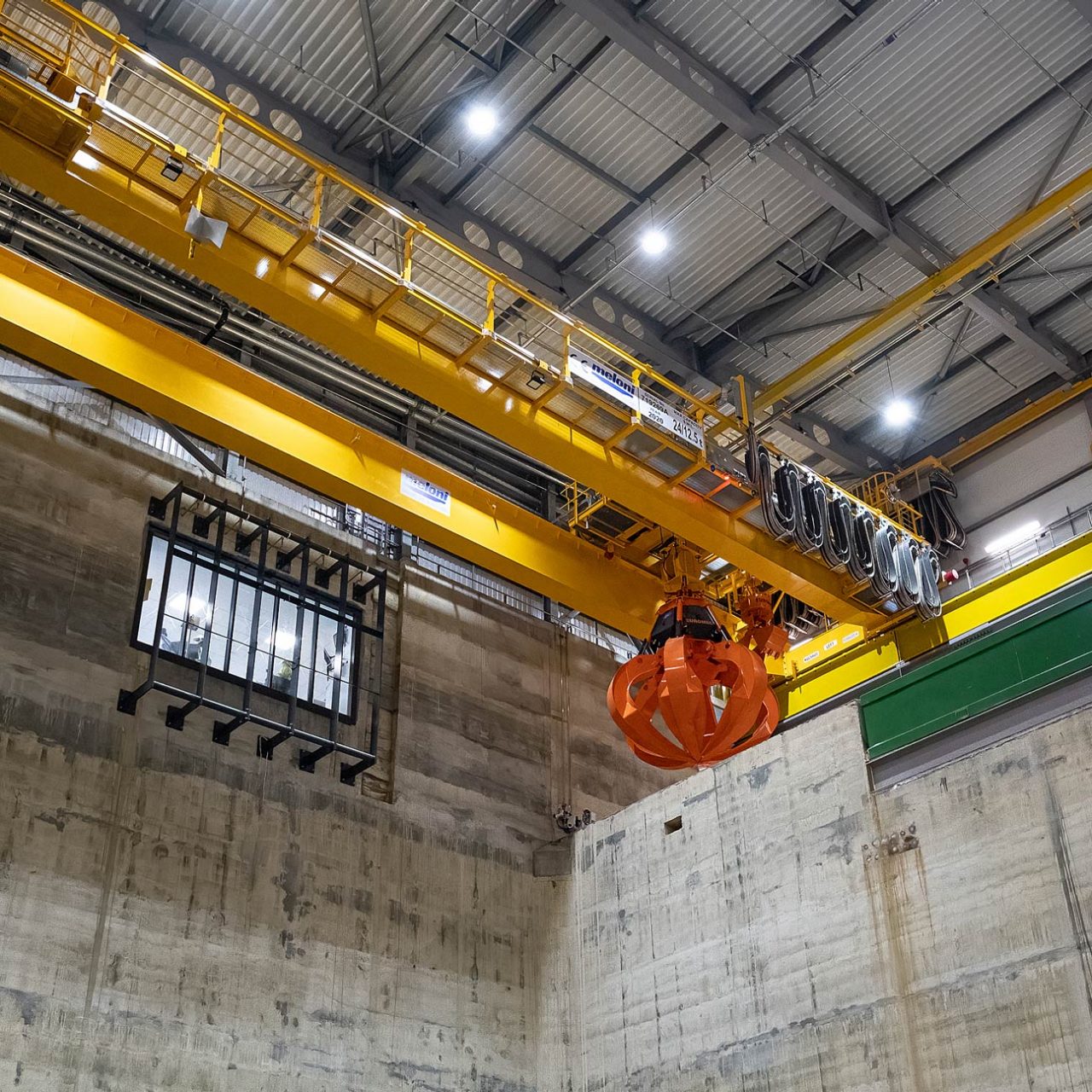 Orange hydraulic grab seen from below