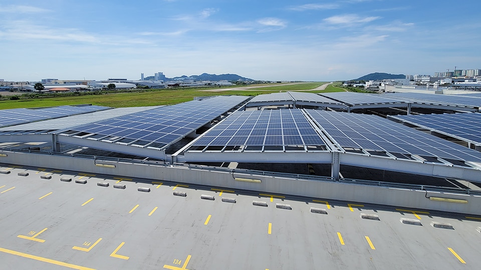 Rooftop solar panels with blue sky above