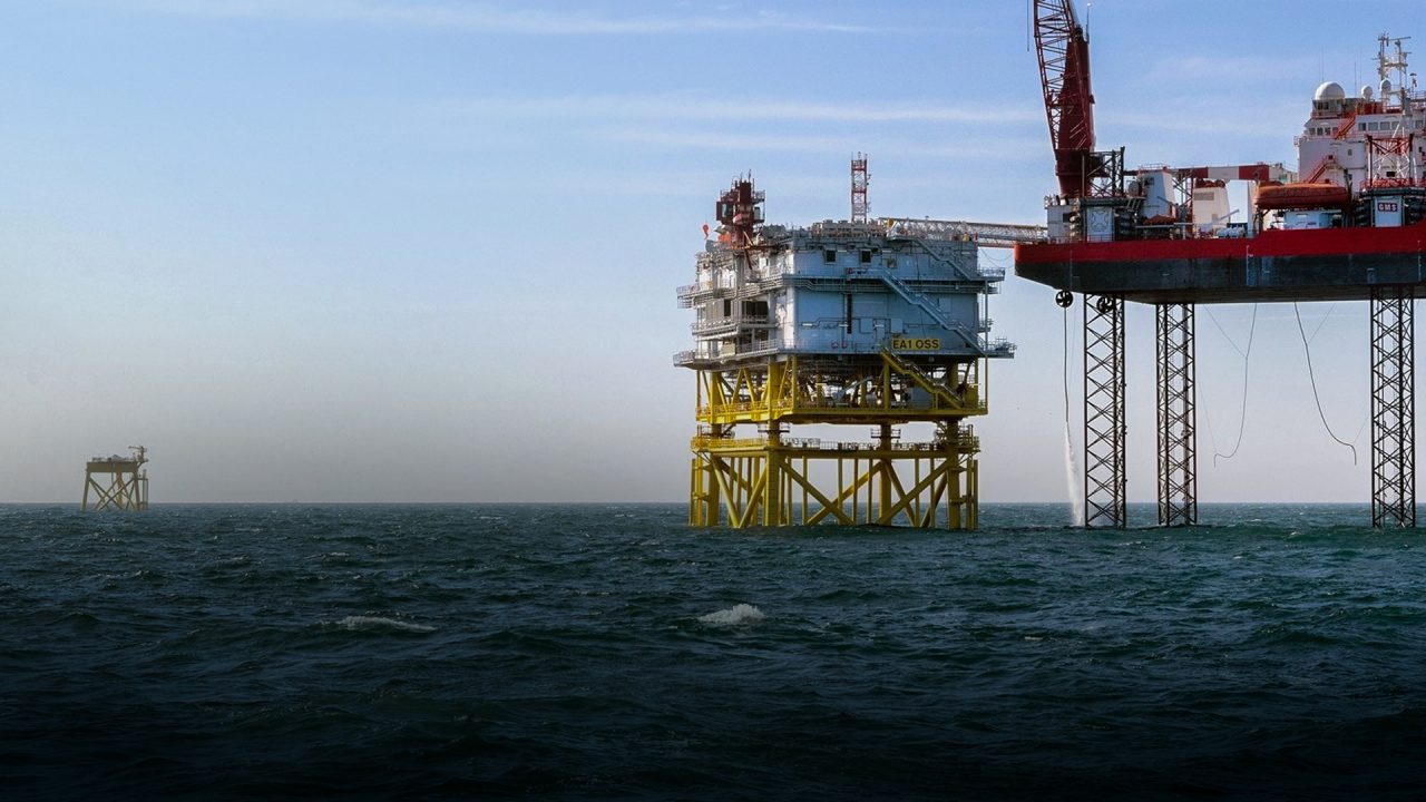 Offshore wind yellow and red turbine platforms in ocean