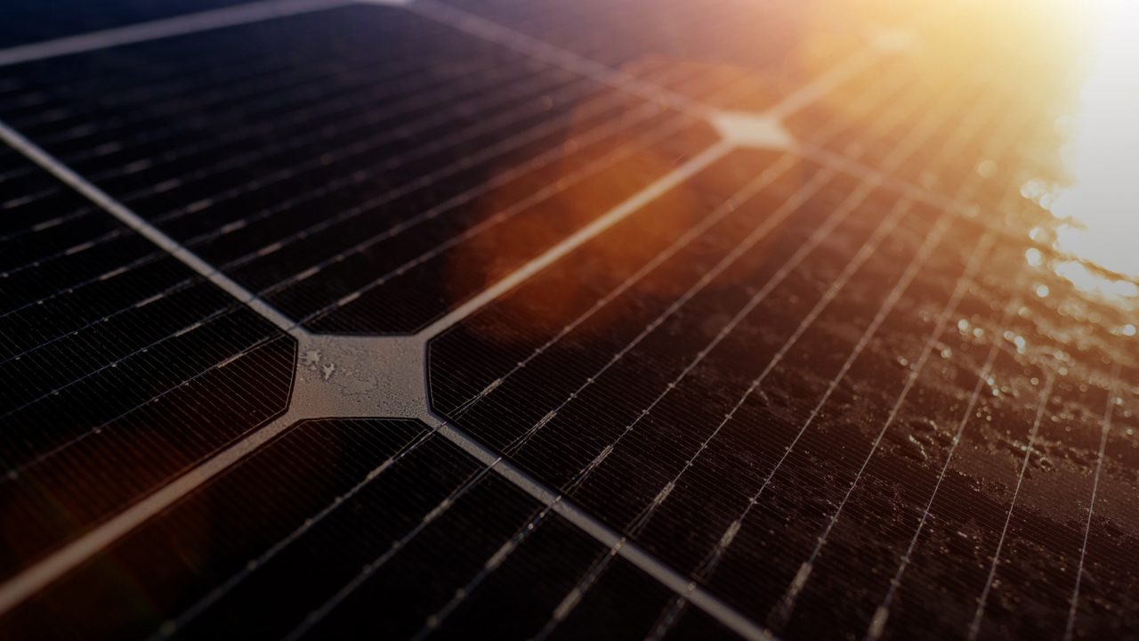Close up of a solar panel with sun reflection