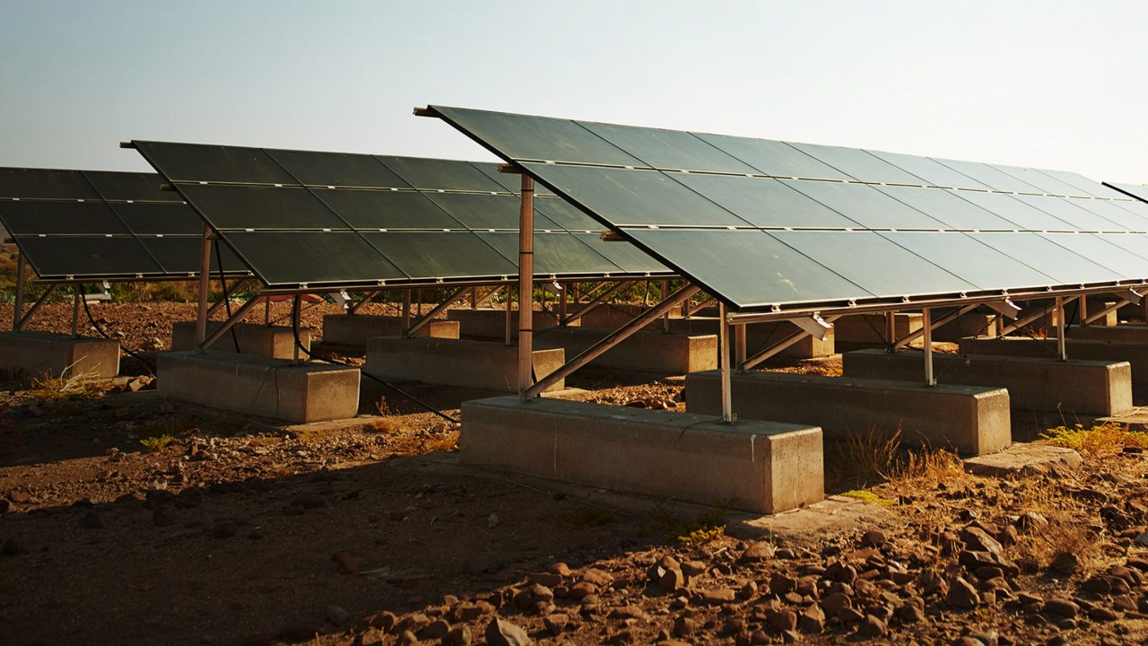 Solar panels in dirt field