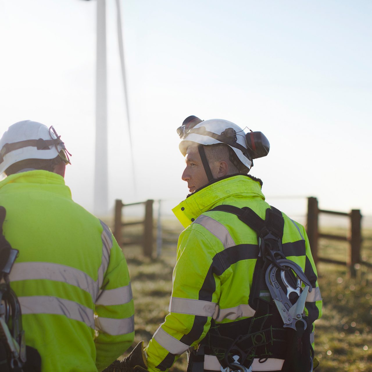 Two engineers at wind farm, walking together